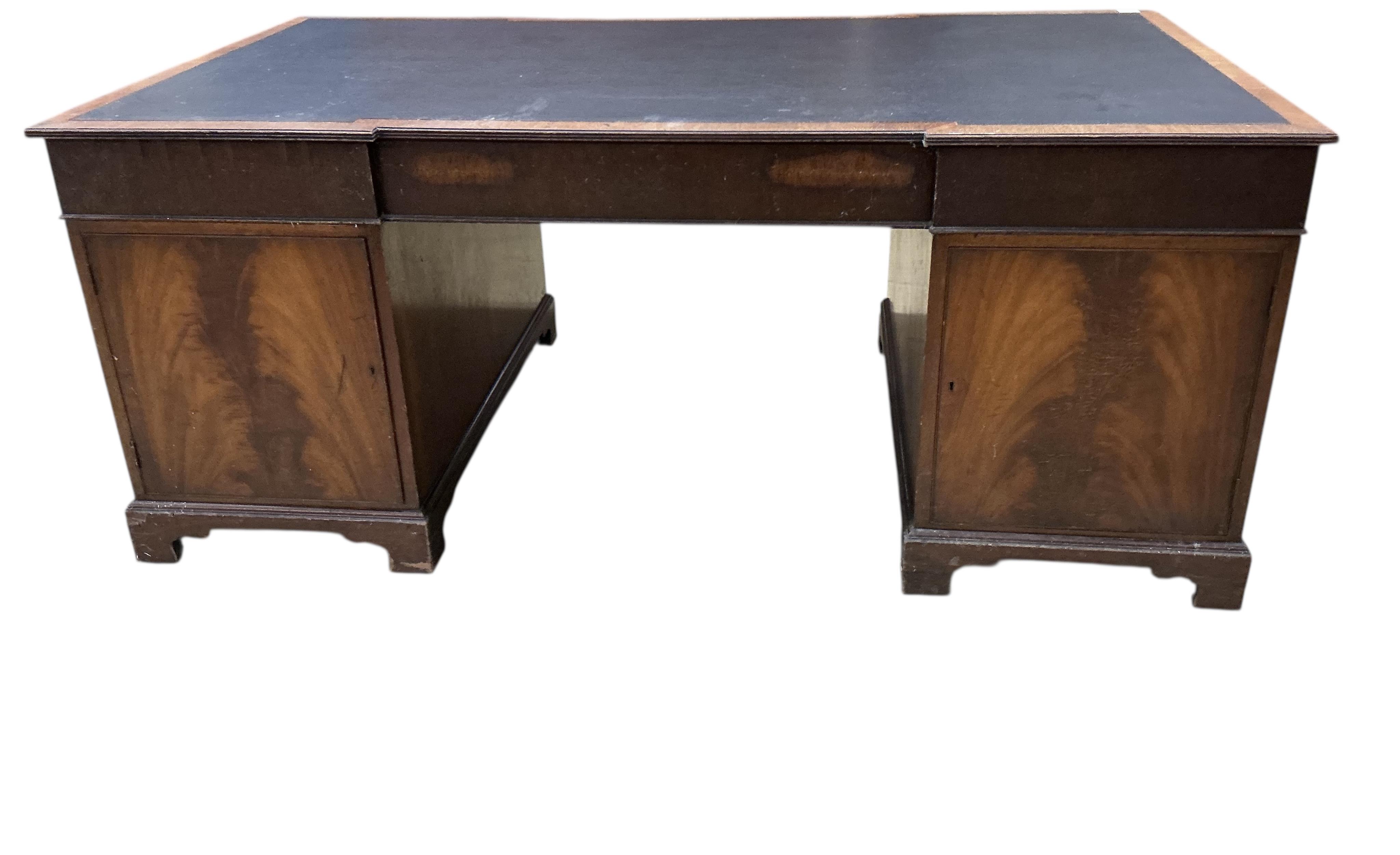 A reproduction George III style mahogany inverse breakfront pedestal desk, width 183cm, depth 99cm, height 76cm